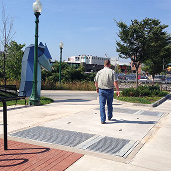 Custom Fabricated large vault cover in sidewalk with man walking over