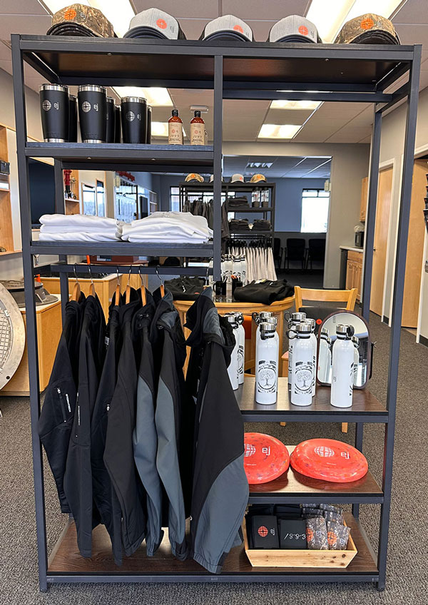 EJ merchandis display with jasckets, shirts, water bottles, frisbees, and more